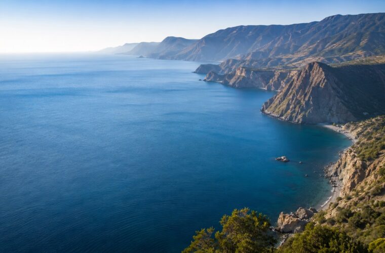 Глубокая синяя акватория Чёрного моря у гористого берега